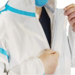 Disposable coverall with tape