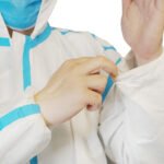 Disposable coverall with tape